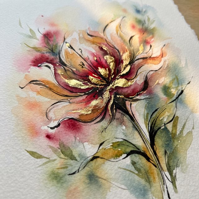 Gently sweeping forms emerge from long, subtle color transitions and soft contours. Bold ink strokes create resilient, confident edges that taper and densify in response to pressure. Raised, polished gold captures directional light in warm, metallic flashes. Luminous, rim-lit gradients blend wet-on-wet into floating patches of color, while a restrained palette of warm ochre, ivory, and deep crimson creates radiant, painterly highlights against a soft, atmospheric background. A flower in the summer wind. — Nano Banana 2 Lite
