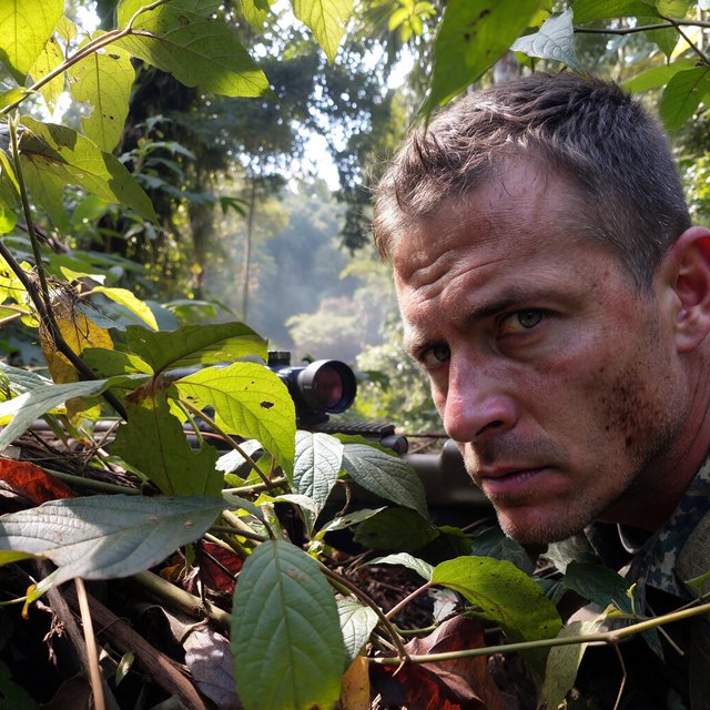An adult sniper concealed in dense jungle foliage, aiming at a distant target, with a close-up view of his focused face. — Model 5