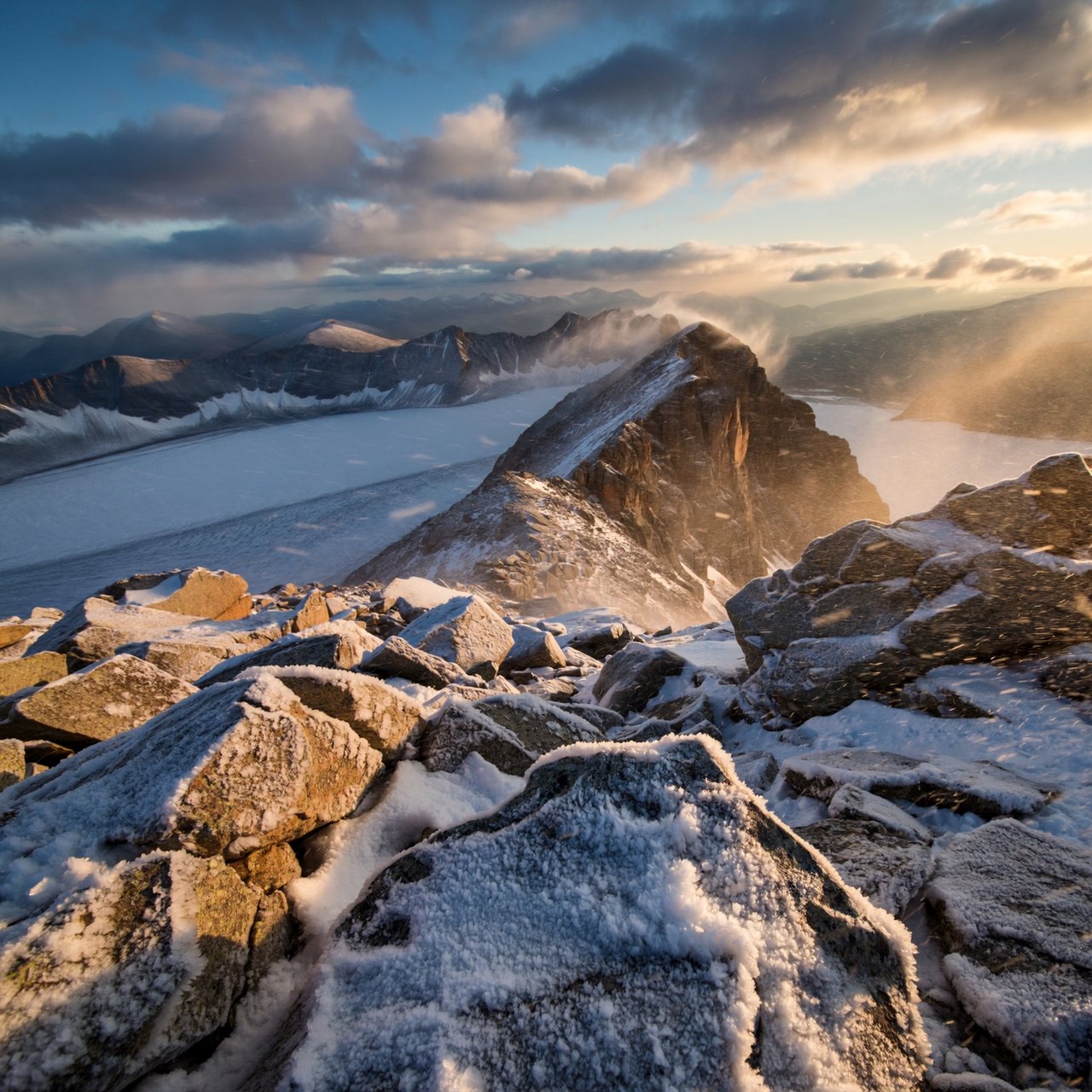 Wind combs a high granite ridge above a glacial cirque at sunrise, beneath clearing snow squalls; granular rime crusts foreground boulders while successive peaks dissolve into blue cloud shadow. — ImagineArt 2