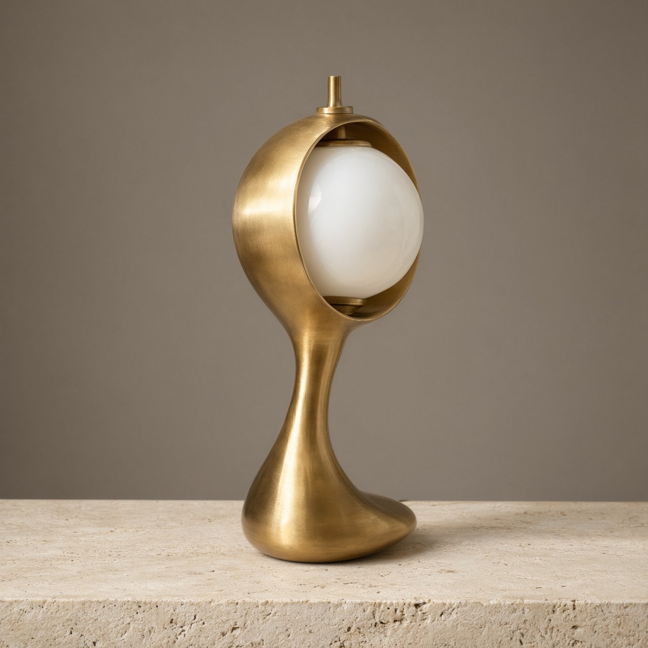 Commercial product photograph of an unbranded sculptural desk lamp made from brushed brass and opal glass, resting on pale travertine, against a warm gray background, with soft diffused light from upper left and gentle grounding shadow. — Qwen Image 3.0 Pro