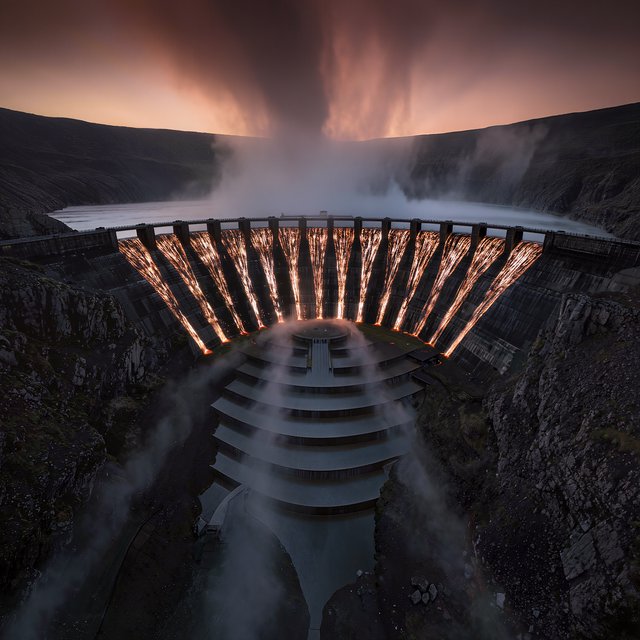 A colossal ring-shaped dam bridges a volcanic caldera, its black stone spillways veined with molten light. Rain veils the terraces as steam rises into a bruised dusk sky. — Kling v3