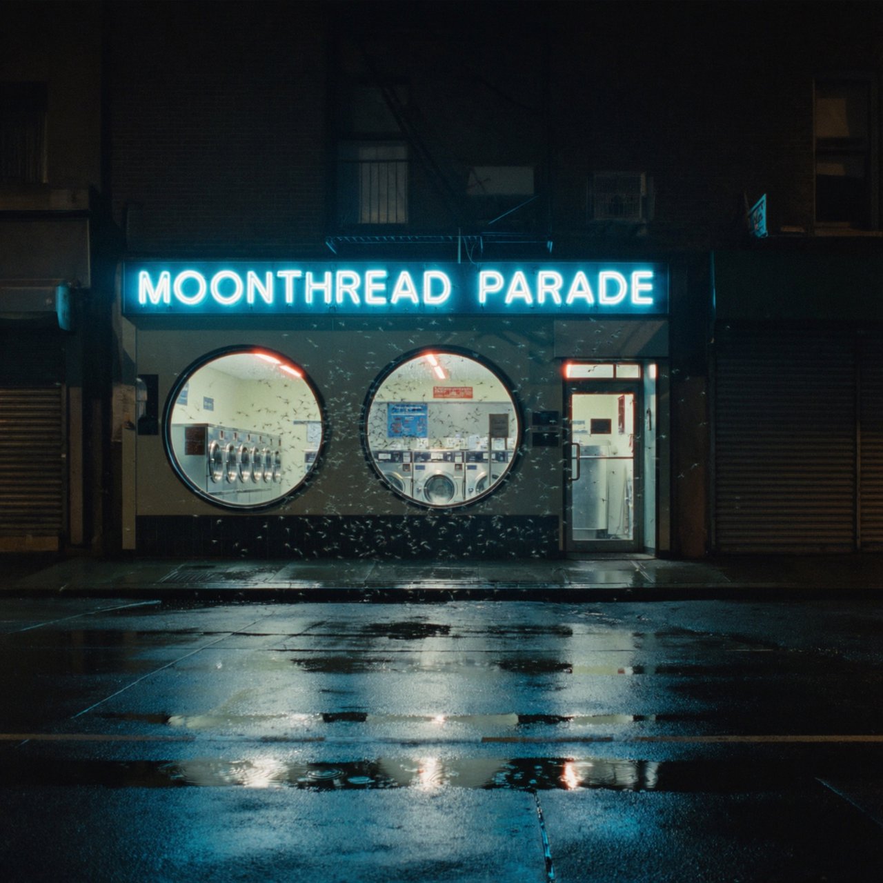At midnight, moths circle the laundromat’s glowing round windows while chrome washing machines gleam inside; “MOONTHREAD PARADE” shines in icy blue neon above the entrance, reflected across the wet pavement, with no other lettering visible. — ImagineArt 2