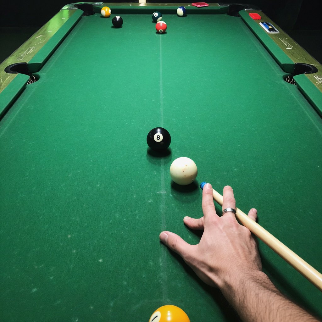 First-person perspective of an adult pool player’s left hand holding the cue, aiming the white cue ball at the black 8-ball and intending to pocket it in the center pocket. — Grok Imagine Image Quality