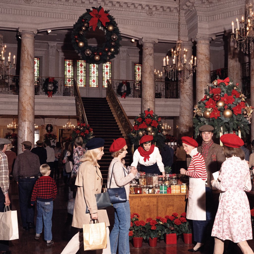 A UK department store in the 1970s at Christmas time. The lighting and decor will be very festive, with staff members dressed in festive outfits. — Recraft v4