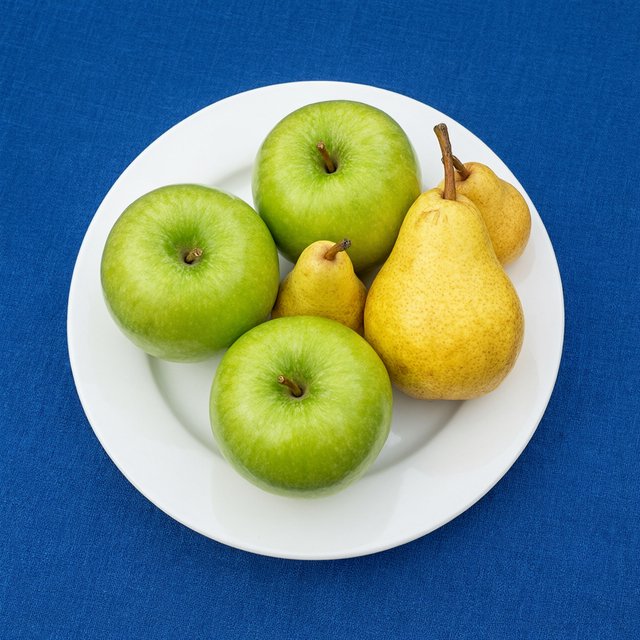 Exactly three green apples and two yellow pears on a white plate, the plate on a blue tablecloth, nothing else on the table. — Qwen Image 3.0 Pro