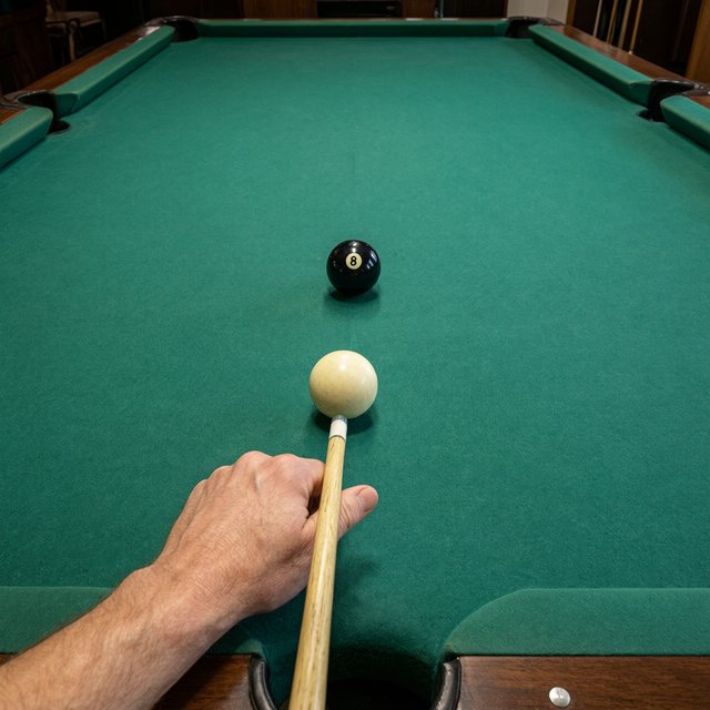 First-person perspective of an adult pool player’s left hand holding the cue, aiming the white cue ball at the black 8-ball and intending to pocket it in the center pocket. — Qwen Image 3.0 Pro