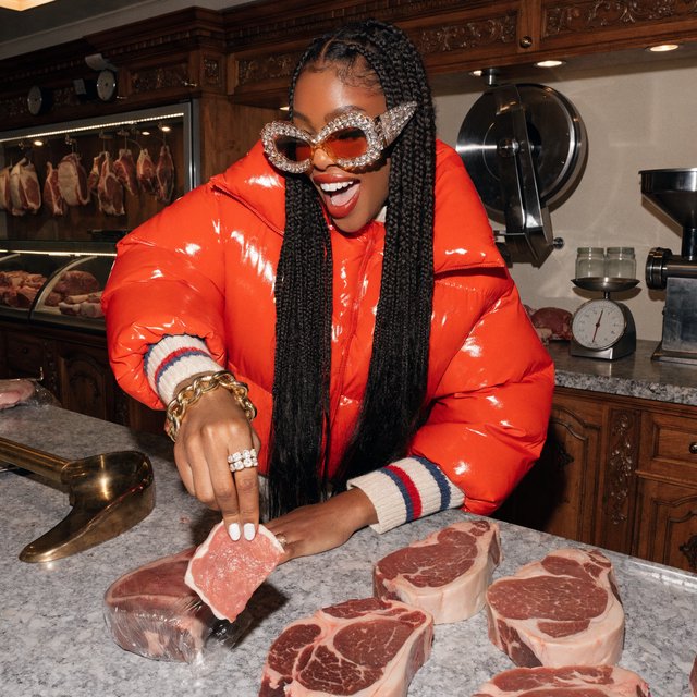 Happy glamorous woman examining meat in a butcher shop. — Recraft v4 Pro