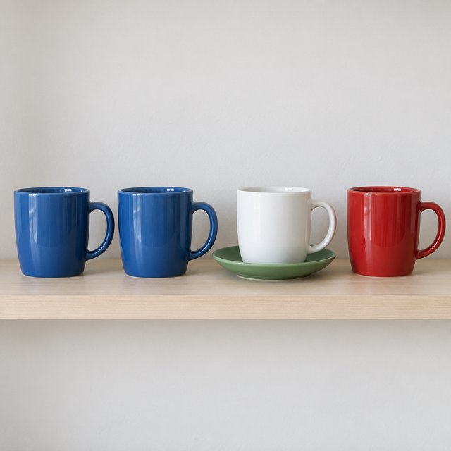 Exactly four ceramic mugs sit on a pale wooden shelf: two blue mugs on the left, one white mug in the center, and one red mug on the right. A green saucer is beneath the center mug, nothing else. — GPT Image 2.5 Sunburst