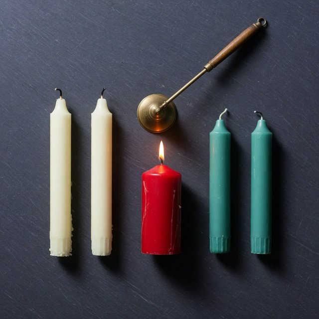 Exactly five candles stand on a dark slate tabletop: two ivory candles on the left, one red candle in the center, and two teal candles on the right. A brass snuffer sits above the red candle, nothing else. — Grok Imagine Image Quality