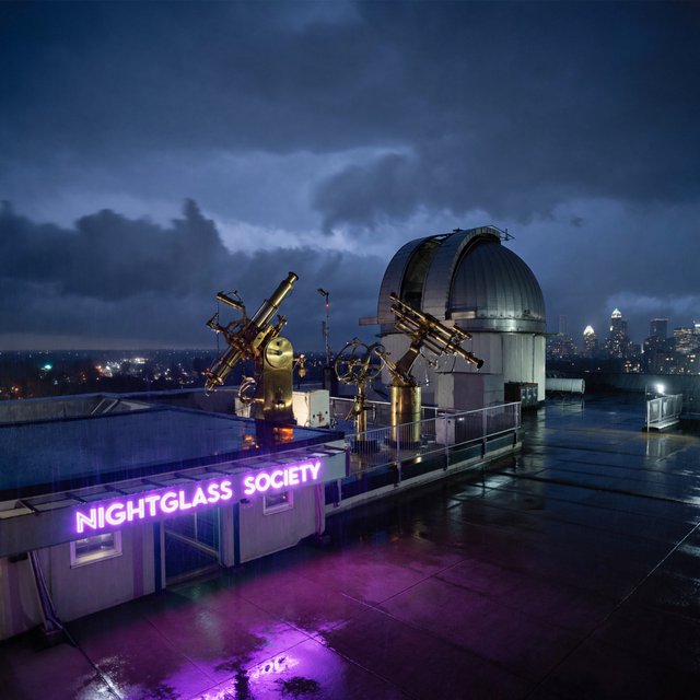 On a rain-darkened rooftop observatory, brass instruments gleam beneath a sliding dome while clouds part above the city; "NIGHTGLASS SOCIETY" glows in violet neon along the entrance canopy. — ImagineArt 2