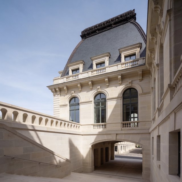 Exterior of a French Second Empire town hall with pale limestone, a dark mansard roof, copper cresting, and tall arched windows; clear spring light falls across the entrance terrace, viewed from the quiet street corner, precise lines and believable construction. — Krea 2 Medium