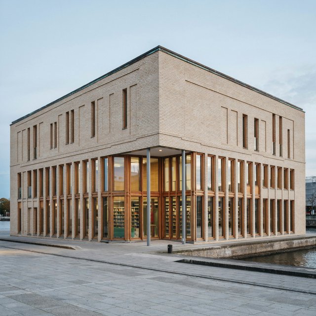 A riverside public library in contemporary Nordic brick architecture combines pale buff brick, oak-framed glazing, and a copper roof; cool morning light grazes its elevations, viewed from across the promenade, with straight lines and credible supports. — Model 8