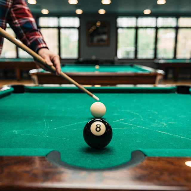 First-person perspective of an adult pool player’s left hand holding the cue, aiming the white cue ball at the black 8-ball and intending to pocket it in the center pocket. — Recraft v4 Pro