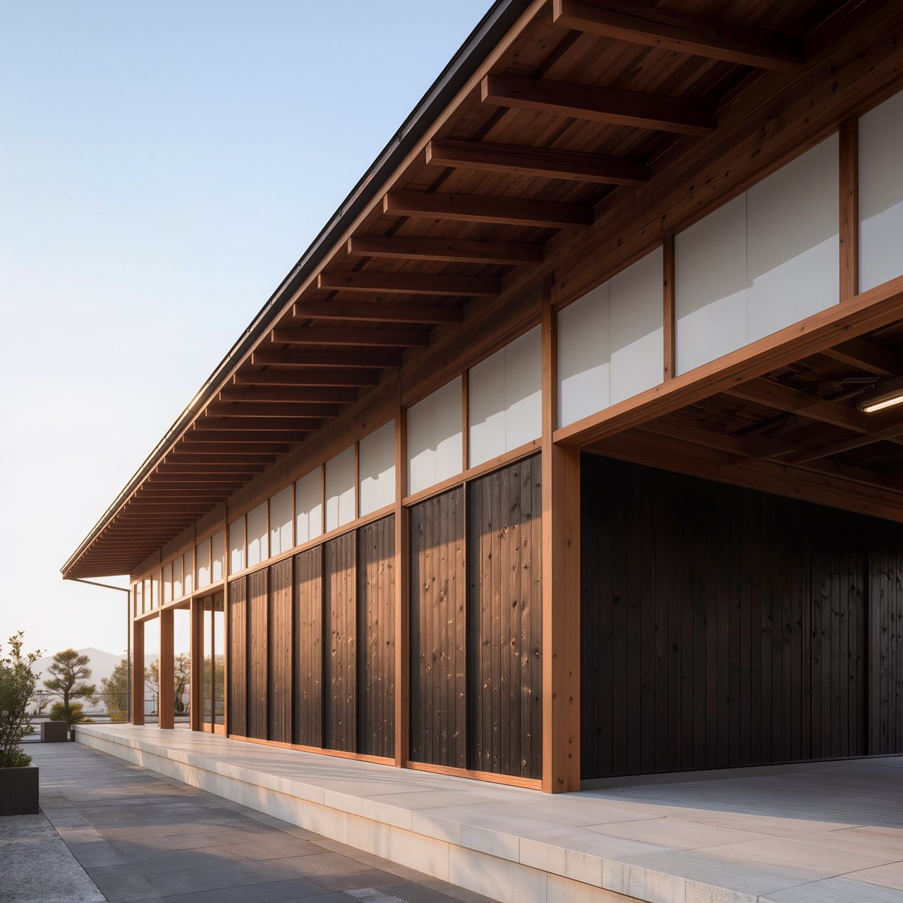 Contemporary Japanese timber train station, charred cedar cladding, pale concrete platform, broad pitched roof with exposed beams and translucent clerestories, cool morning light, viewed obliquely from the quiet approach plaza, precise straight lines and plausible structure. — Kling v3