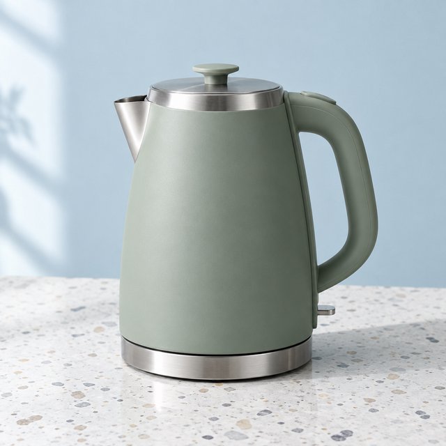 Commercial product photograph of an unbranded electric kettle made from matte sage ceramic and brushed stainless steel, resting on a white terrazzo surface against a pale blue background, with soft window light from the left and a delicate grounding shadow. — GPT Image 2.5 Flare