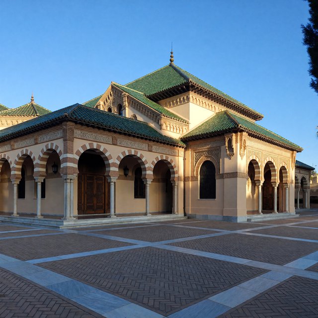 Exterior of a Moorish Revival municipal bathhouse, pale buff stucco, striped brick arches, green glazed tile roof and carved cedar doors; clear morning light, viewed across a paved courtyard, with coherent structure and crisp lines. — ImagineArt 1.5 Pro