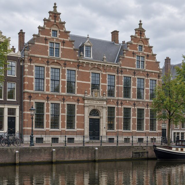 Exterior of a Dutch Renaissance canal-side archive, with warm red brick, pale stone bands, stepped gables, and tall sash windows; soft overcast light reveals the masonry, viewed from the opposite quay, with convincing structure and precise architectural lines. — GPT Image 2.5 Flare