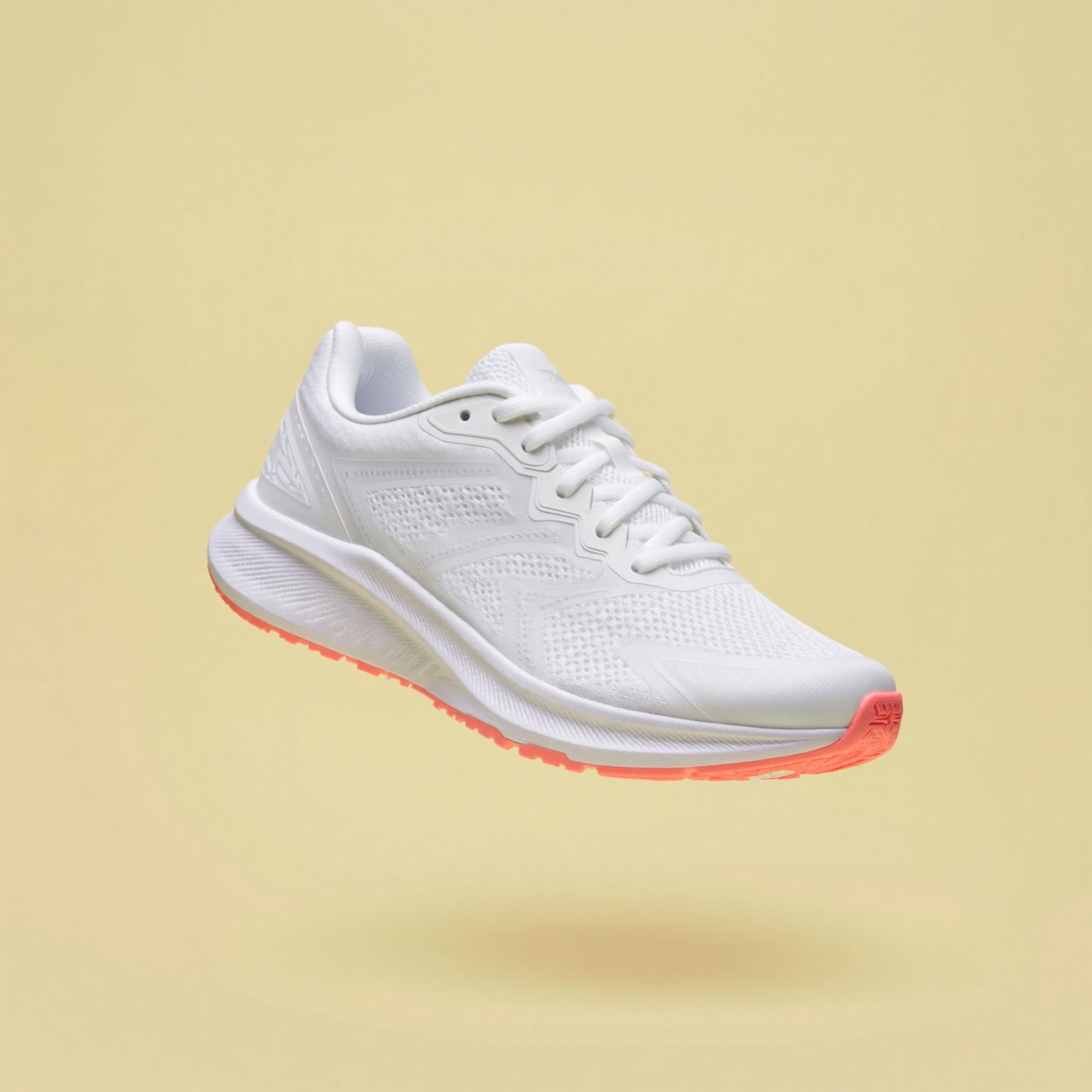 A white running sneaker with a coral sole floating at a slight angle over a pastel yellow background, studio lighting, no shadow on the backdrop. — ImagineArt 2