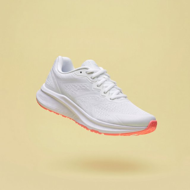 A white running sneaker with a coral sole floating at a slight angle over a pastel yellow background, studio lighting, no shadow on the backdrop. — ImagineArt 2
