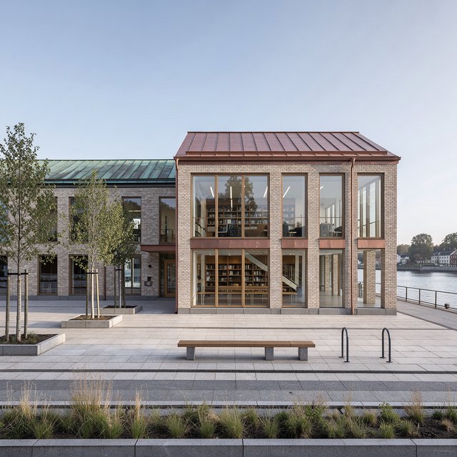 A riverside public library in contemporary Nordic brick architecture combines pale buff brick, oak-framed glazing, and a copper roof; cool morning light grazes its elevations, viewed from across the promenade, with straight lines and credible supports. — Model 1