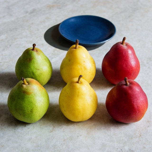 Exactly six ripe pears sit on a pale stone counter: two green pears on the left, two yellow pears in the center, and two red pears on the right. A small blue plate sits above the center pair, nothing else. — Krea 2 Large