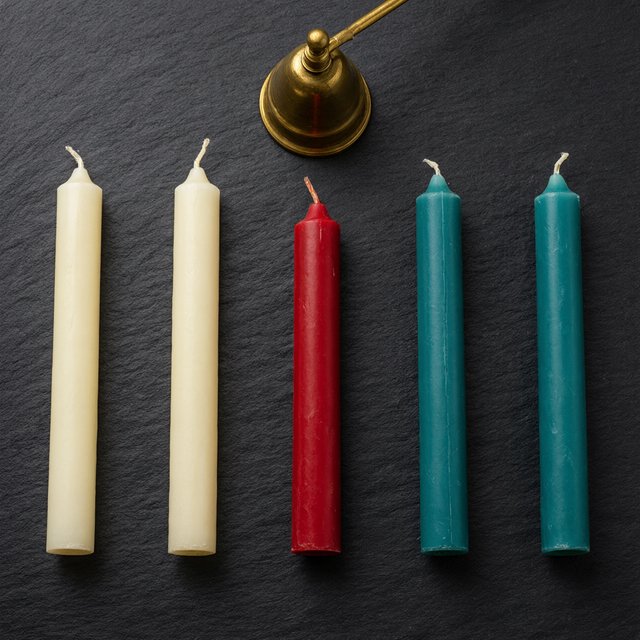 Exactly five candles stand on a dark slate tabletop: two ivory candles on the left, one red candle in the center, and two teal candles on the right. A brass snuffer sits above the red candle, nothing else. — Qwen Image 3.0 Pro