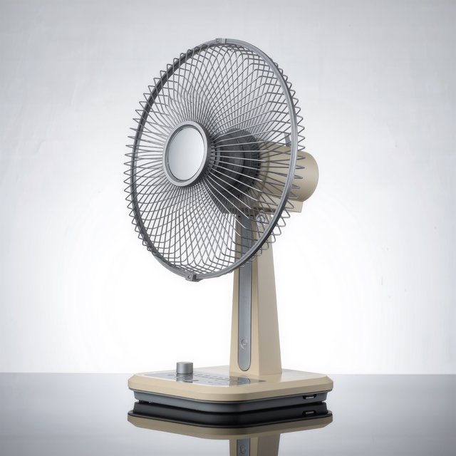 Commercial product photograph of an unbranded desktop fan made from brushed aluminum and matte ivory polymer, resting on a smoked glass surface against a pale gray background, illuminated by broad diffused studio light and a soft rear rim light. — Kling v3 Omni