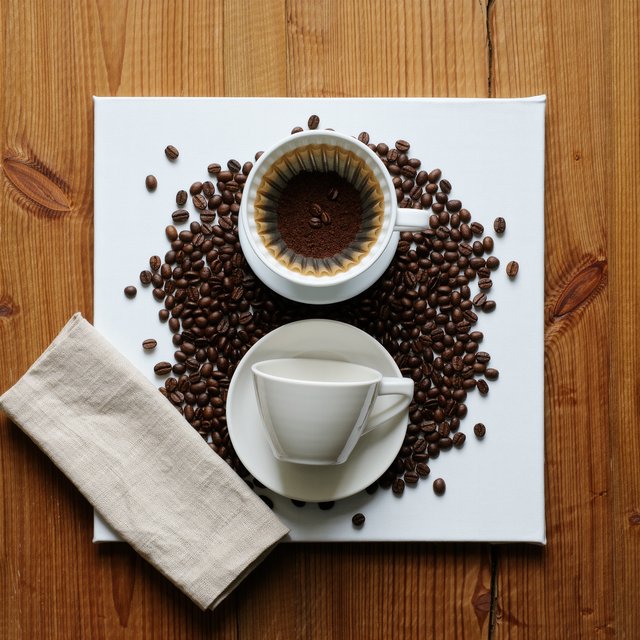Overhead flat lay of a ceramic pour-over coffee set on oak, roasted beans scattered, a folded linen napkin, warm natural light. — Kling v3 Omni