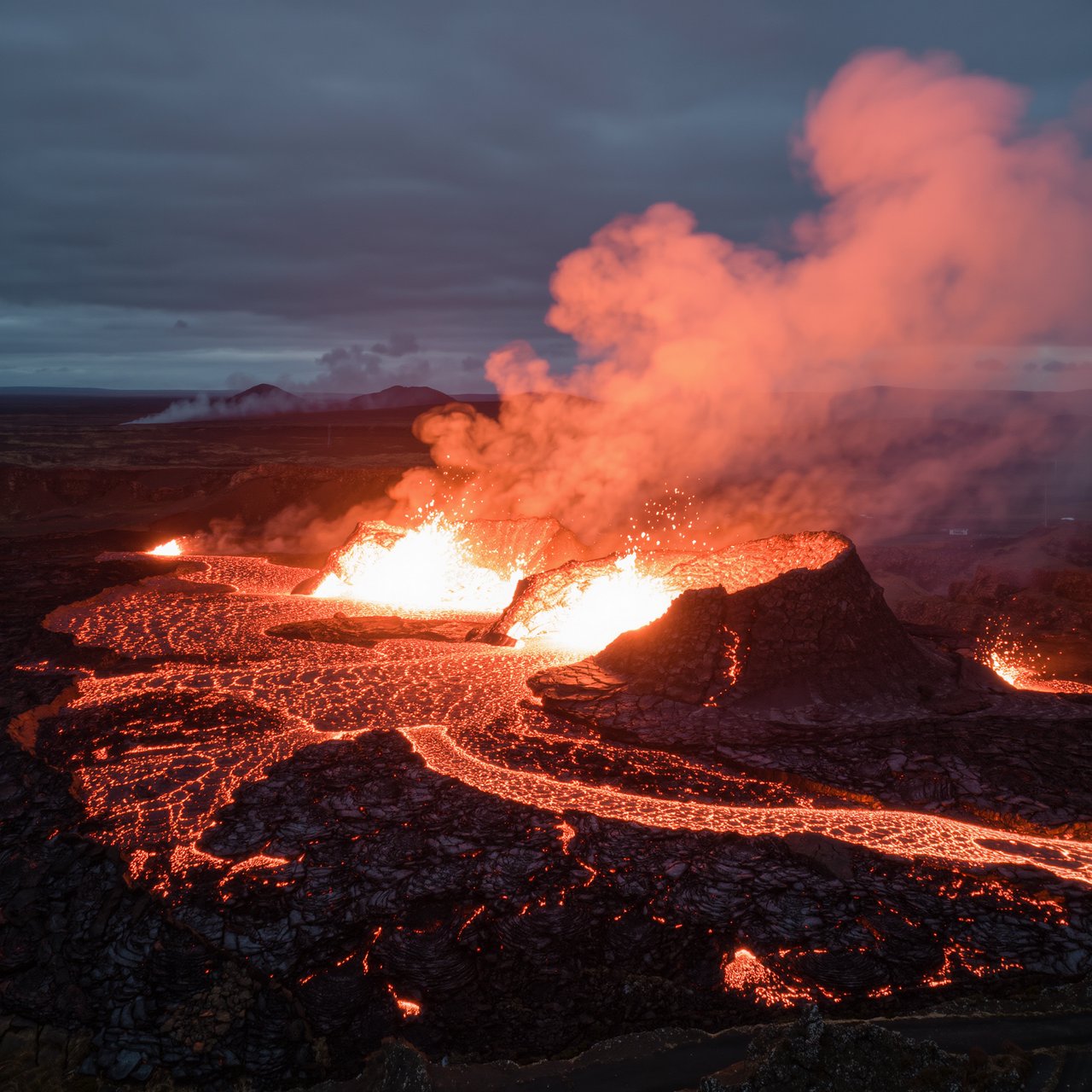 Fresh lava threads a black cinder plain on a volcanic island at dusk beneath ash-laden wind; blistered crust and brittle pumice in the foreground give way to glowing fissures fading into smoke. — Kling v3 Omni