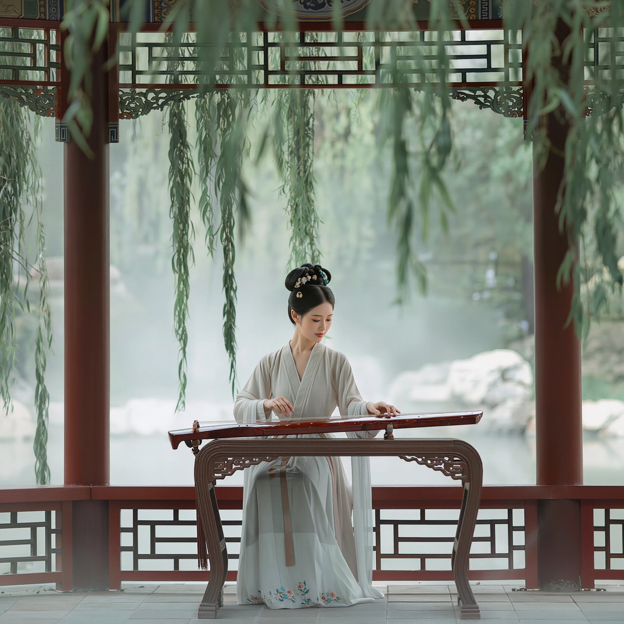 An elegant ancient Chinese lady in hanfu plays the guzheng in a quiet garden pavilion, surrounded by willow trees and mist, creating a poetic atmosphere. — Kling v3