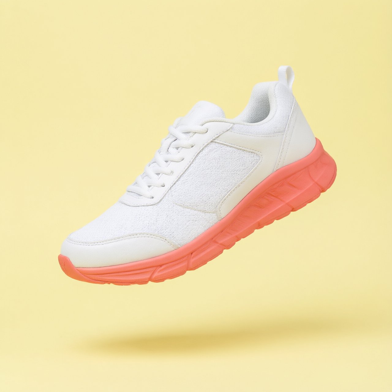 A white running sneaker with a coral sole floating at a slight angle over a pastel yellow background, studio lighting, no shadow on the backdrop. — Qwen Image 3.0