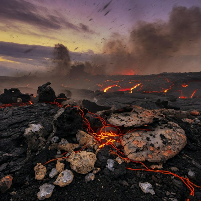 Fresh lava threads a black cinder plain on a volcanic island at dusk beneath ash-laden wind; blistered crust and brittle pumice in the foreground give way to glowing fissures fading into smoke. — Grok Imagine Image Quality