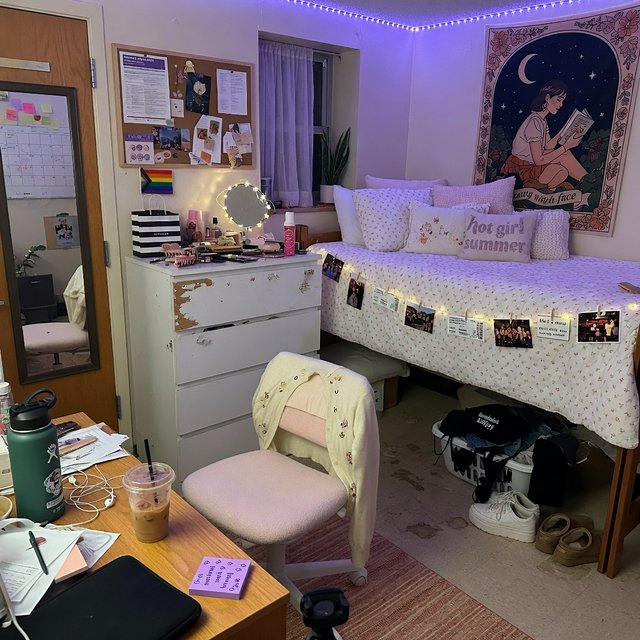A dorm room belonging to an adult woman, photographed with a cell phone. The camera is sitting on a desk facing the empty chair and the rest of the room. — Grok Imagine Image Quality