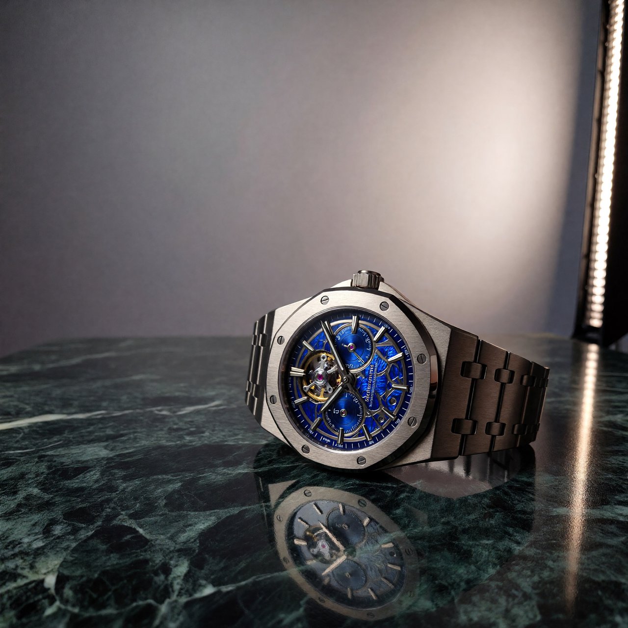 Commercial product photograph of an unbranded mechanical wristwatch with a brushed titanium case and deep blue enamel dial, resting on dark green marble against a soft gray background, illuminated by a large diffused softbox and narrow edge light. — ImagineArt 1.5 Pro