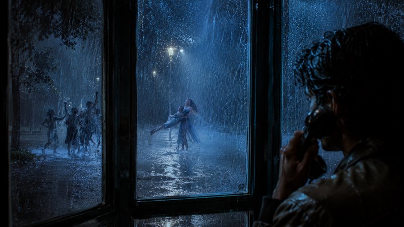 Silhouetted man on a vintage phone watches people dance and celebrate in heavy pouring night rain...