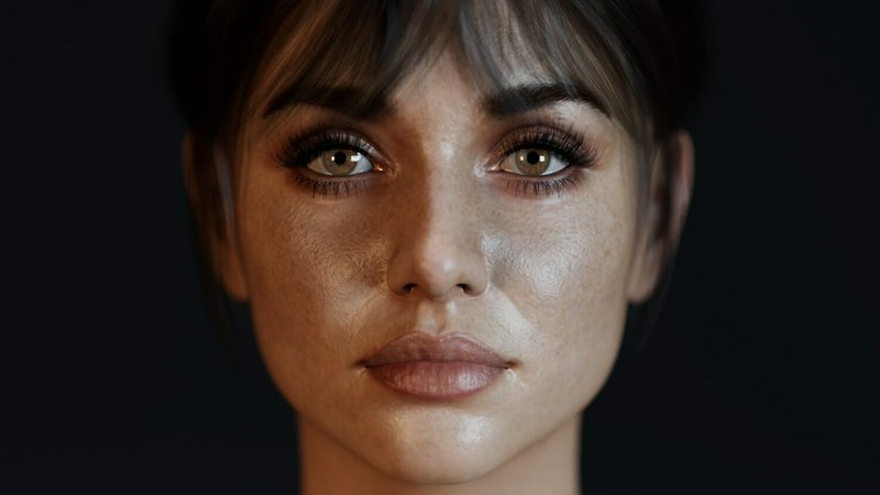 Close-up portrait of a woman with dewy skin and soft makeup against a dark background
