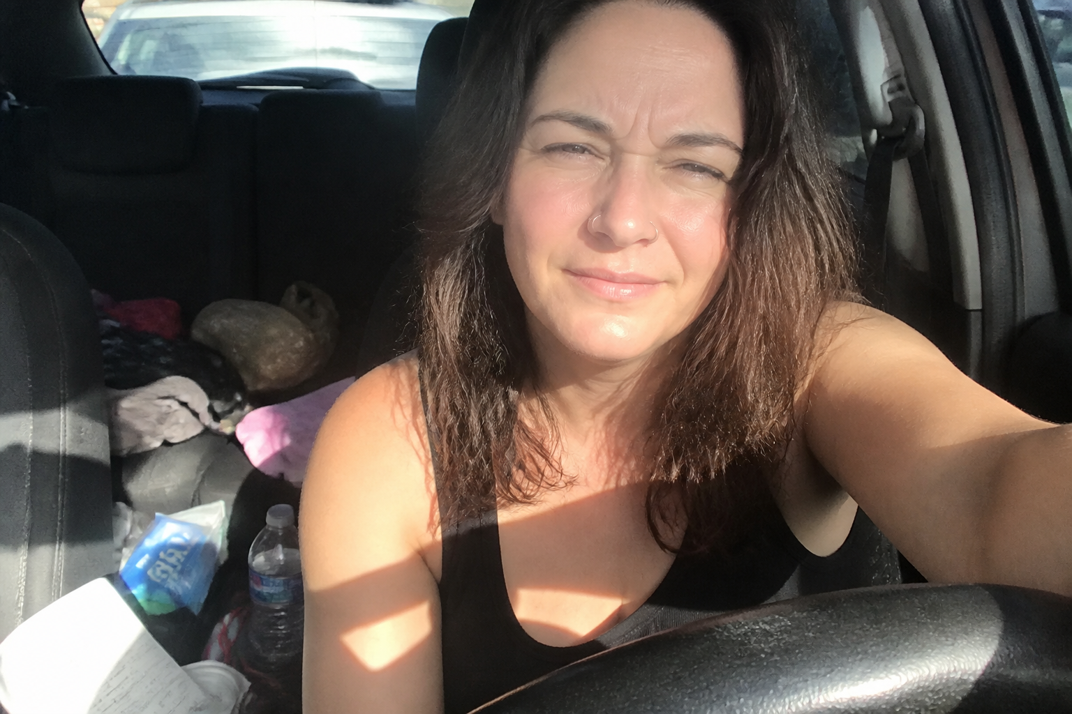 Glary car selfie → shaded patio portrait (before)