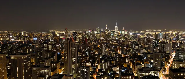 High angle wide view of a glittering illuminated city skyline after dark