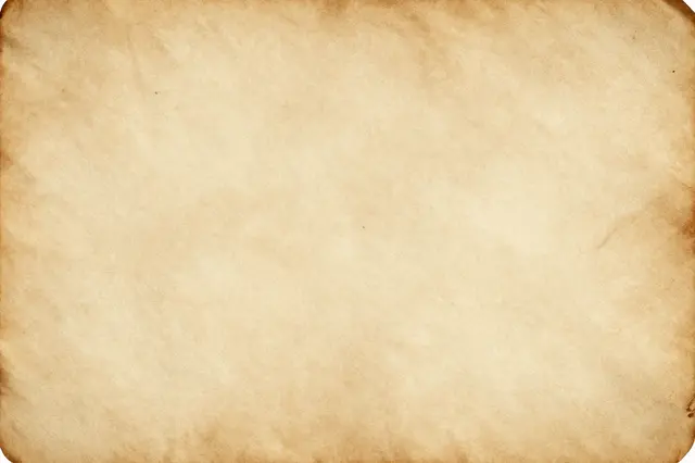 Full frame close-up of warm, discolored aged parchment with subtly darkened uneven edges