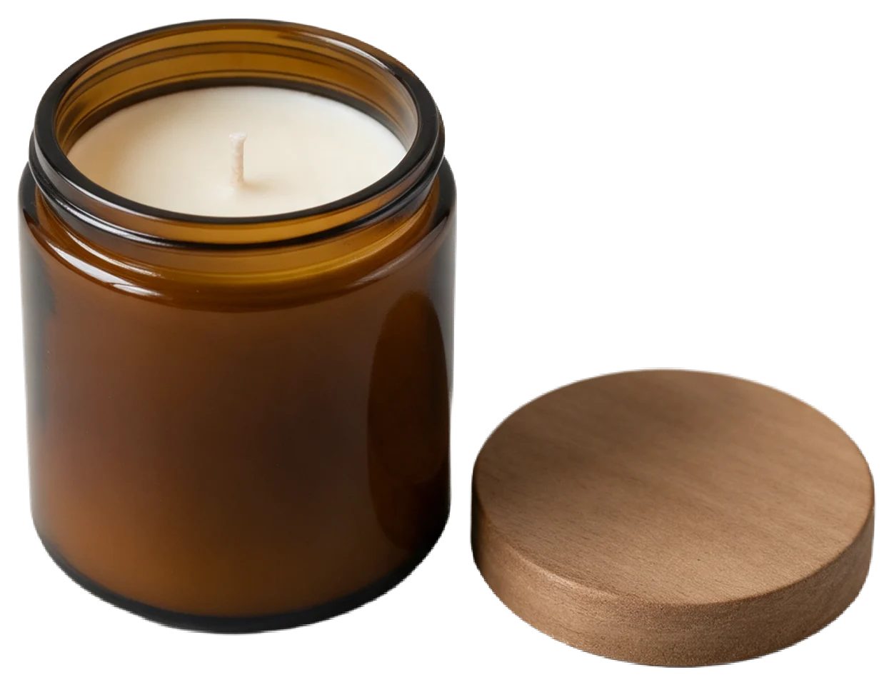 Unlit hand-poured soy candle in an amber glass jar with its wooden lid set beside it