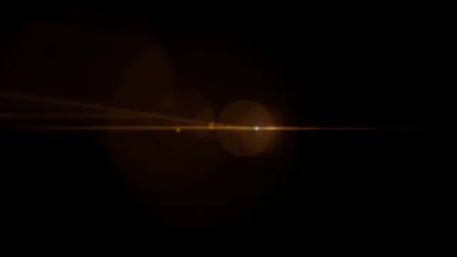 Subtle amber lens flare with horizontal streaks and round bokeh orbs on a solid pure black background
