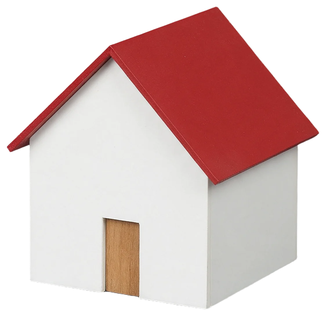 Small white model house with a red gabled roof and wooden front door