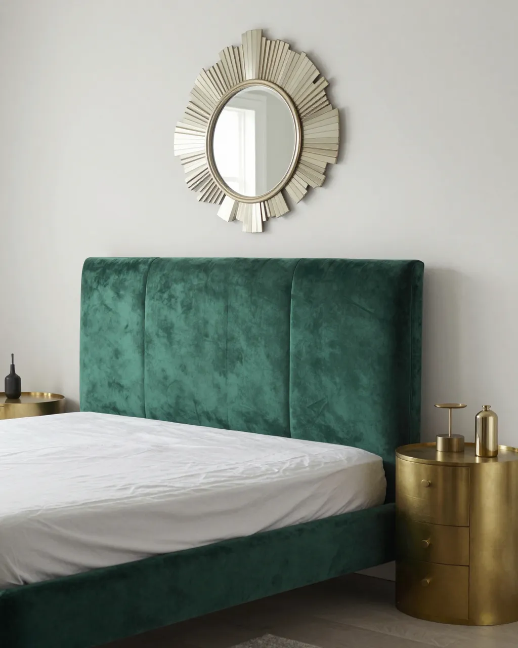 Stylish Art Deco bedroom with emerald velvet headboard, brass nightstands and fan-shaped wall mirror