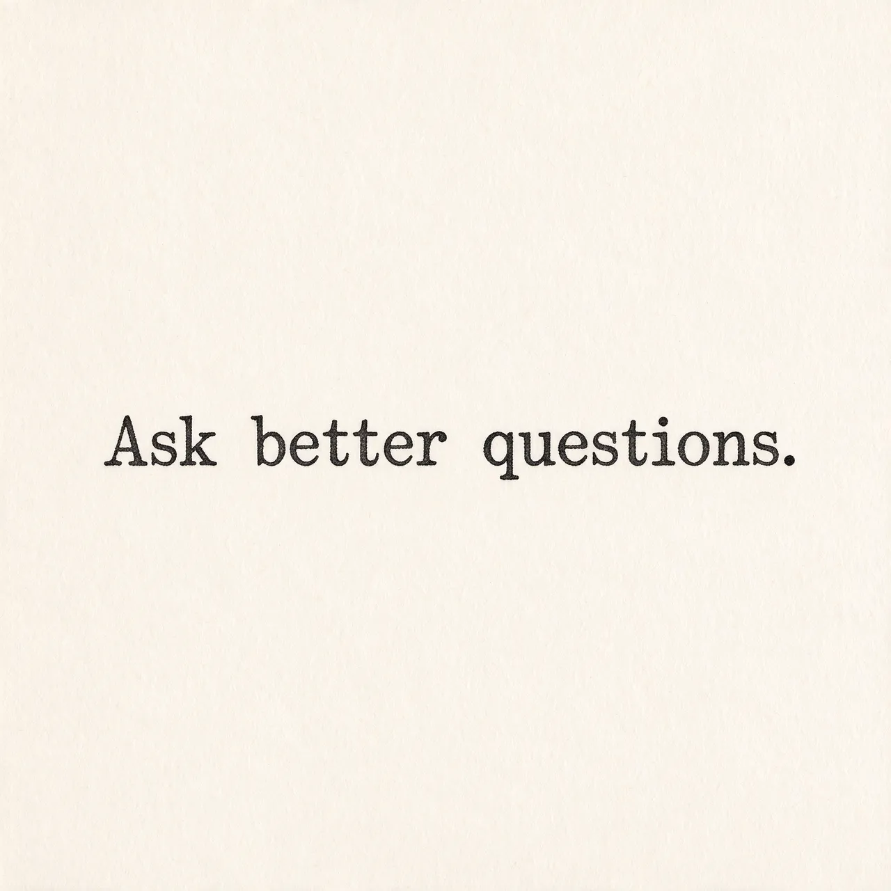 Typewriter text reading "Ask better questions." centered on warm off-white textured paper