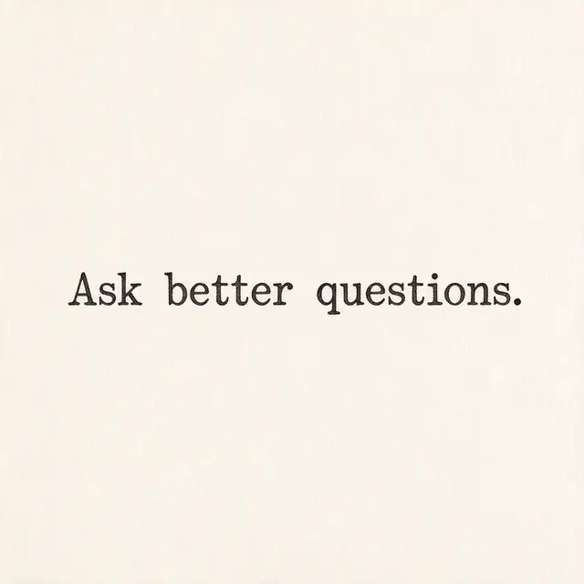 Typewriter text reading "Ask better questions." centered on warm off-white textured paper