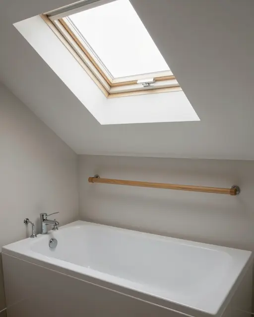 Minimalist attic bathroom featuring a sloped ceiling, overhead skylight, white tub and wooden towel rail