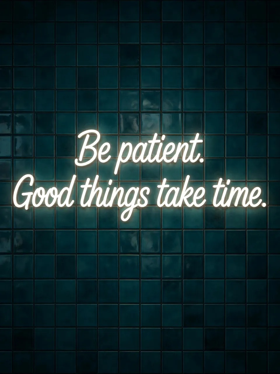 Glowing white neon sign reading "Be patient. Good things take time." on a dark teal tiled wall