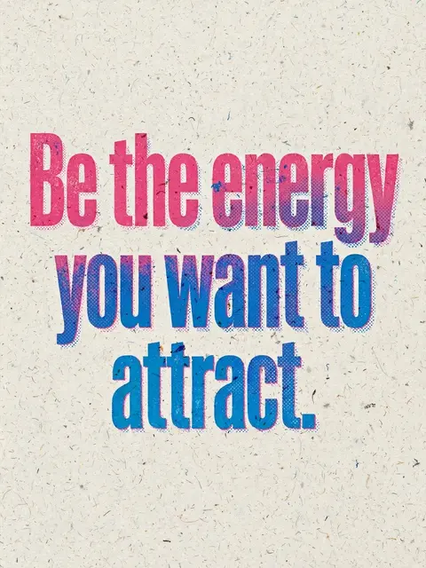 Risograph print with pink and blue gradient bold text reading "Be the energy you want to attract" on speckled off-white paper