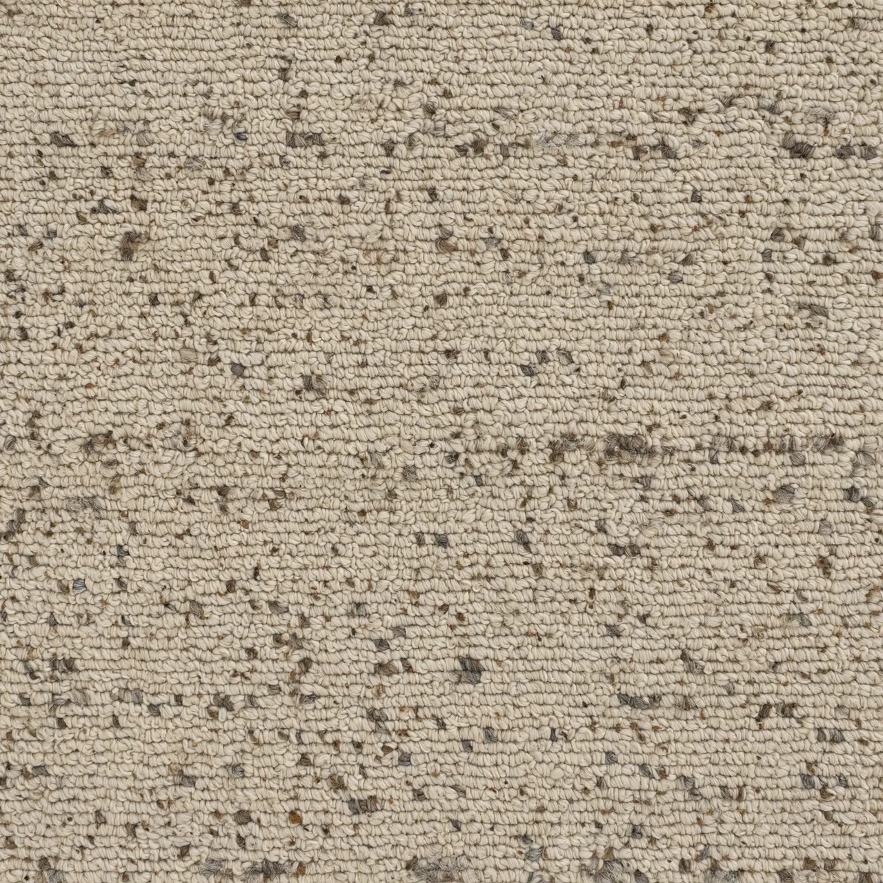 Full frame top view of a beige looped wool berber carpet flecked with brown and gray