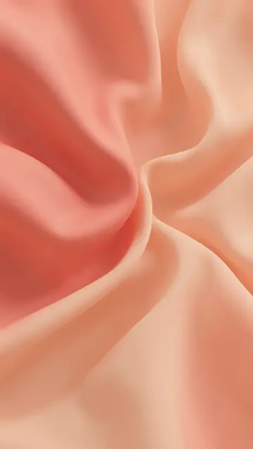 Smooth flowing 3D fabric in soft gradient coral and peach folds fills the vertical frame